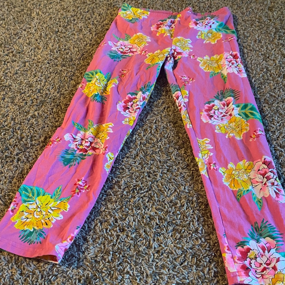 Bright pink leggings with bold floral pattern